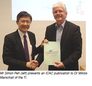 Mr Simon Peh (left) presents an ICAC publication to Dr Miklos Marschall (right) of the TI.