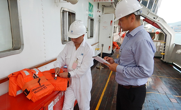 An officer of the CPD conducts an assignment study with a Marine Department officer on board a ship.