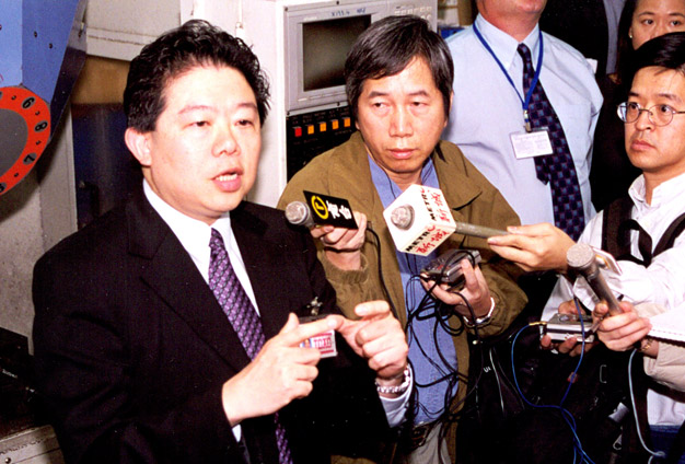 Mr Chu (left) briefs reporters on an ICAC operation